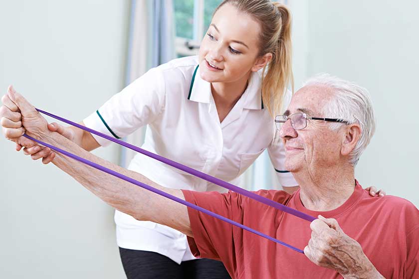 senior male working with physiotherapist senior male working with physiotherapist