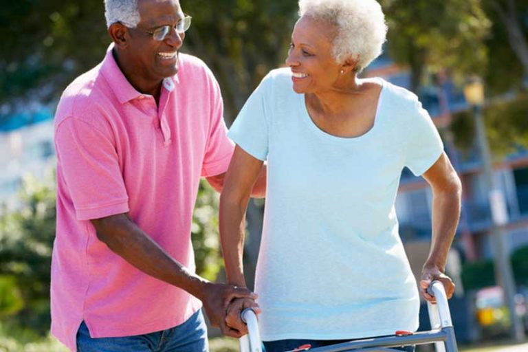 senior man helping wife