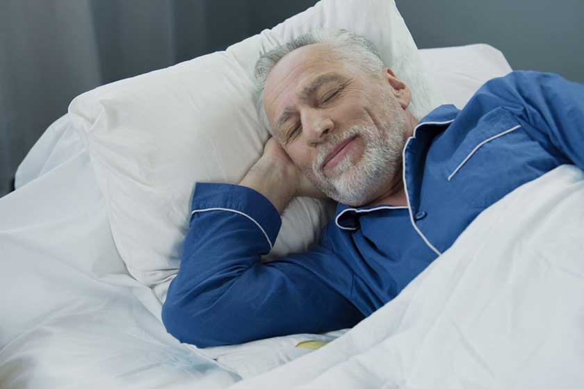 senior man smiling while asleep