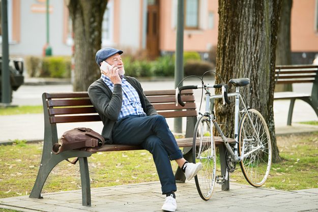 senior man with bicycle and smart phone making phone call senior man with bicycle and smart phone making phone call