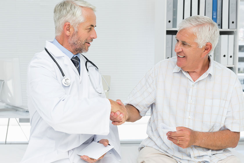 specialist doctor and patient smiling and talking