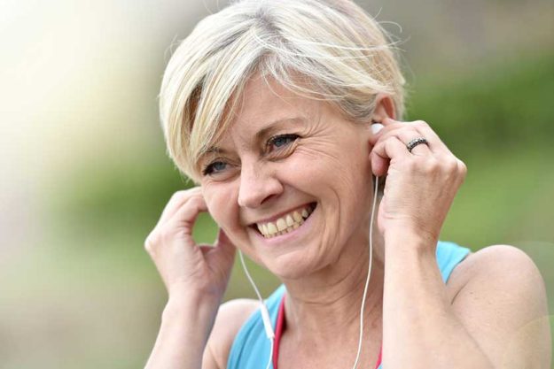woman adjusting earphones