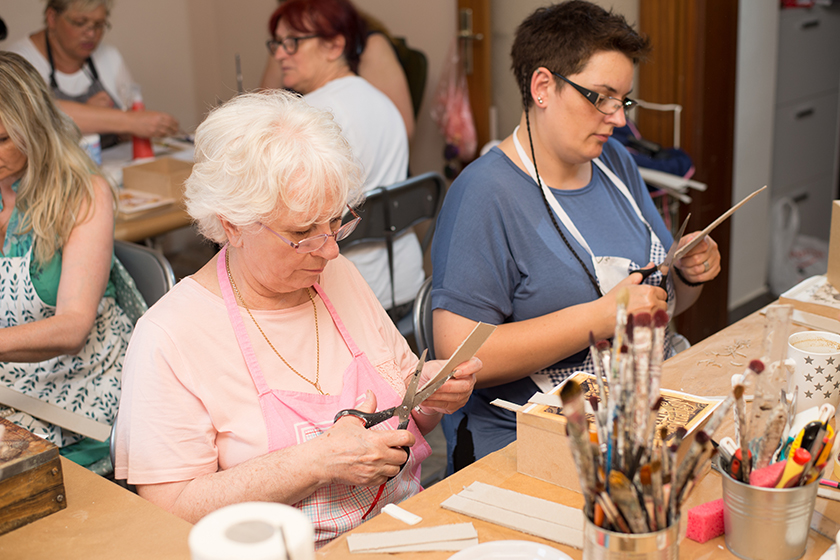 women in art workshop making decoupage boxes