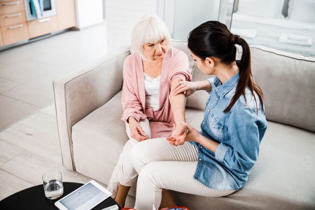 young doctor checking old lady