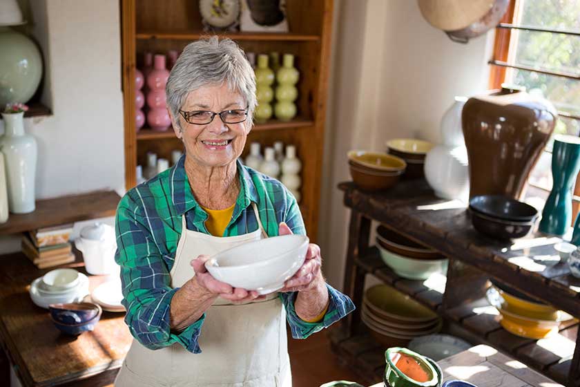female potter holding bowl