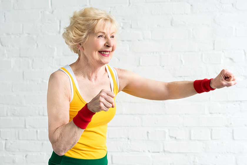 happy senior woman sportswear boxing
