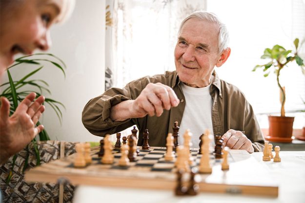 portrait of senior couple playing chess