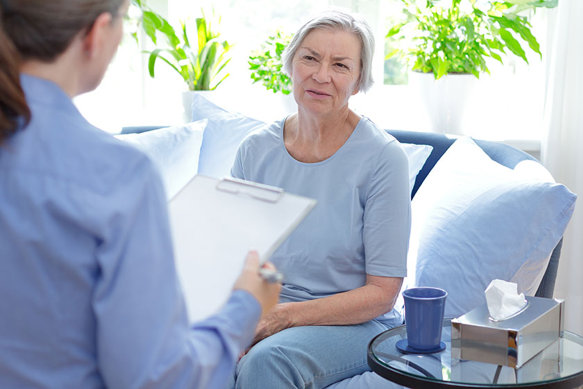 psychotherapist taking notes during a therapy session