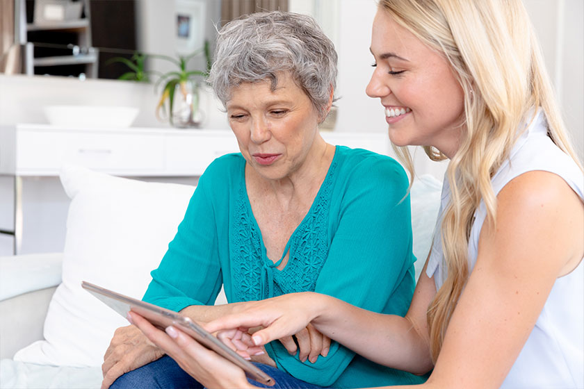 senior caucasian woman wearing green shirt her adult daughter