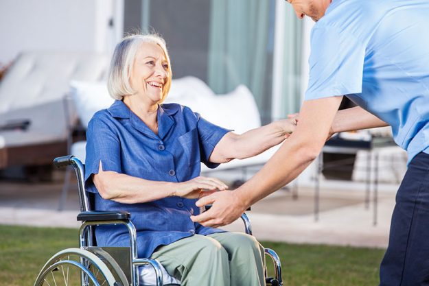 senior woman with disability to sit on wheelchair