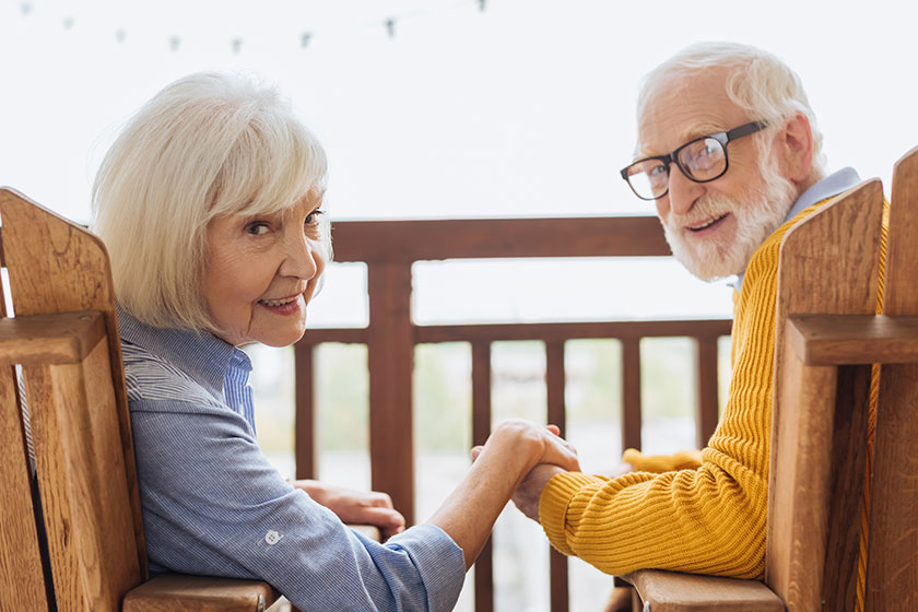 smiling elderly couple looking camera