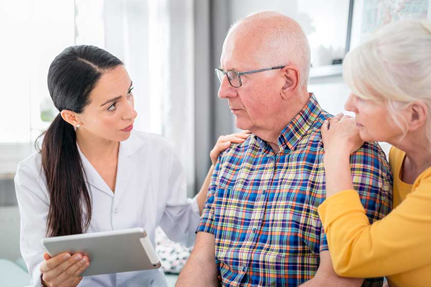 elderly couple consulting with doctor