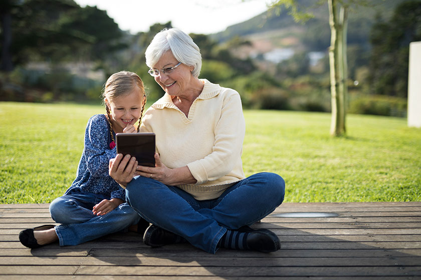 granddaughter and grandmother using tablet