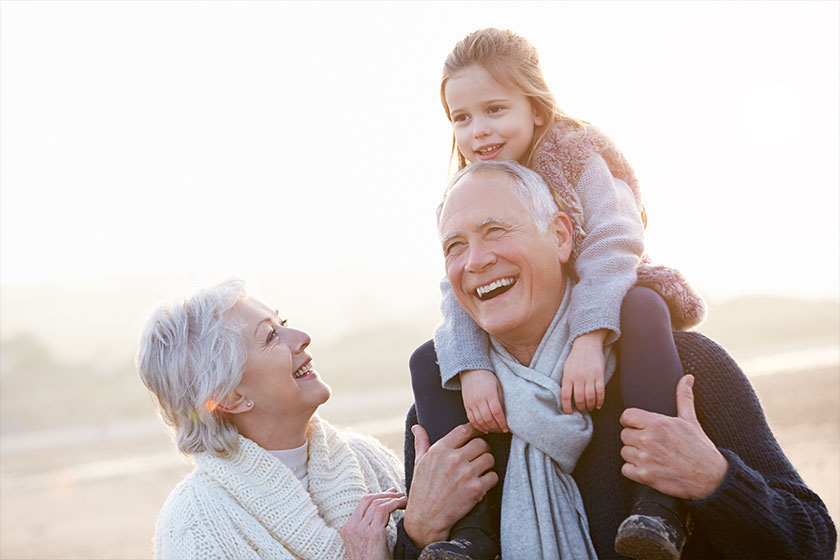 grandparents and granddaughter walking