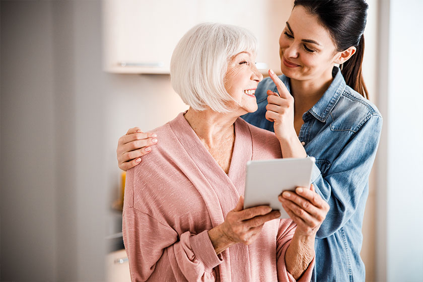 happy grandmother and adult granddaughter having fun at home happy grandmother and adult granddaughter having fun at home