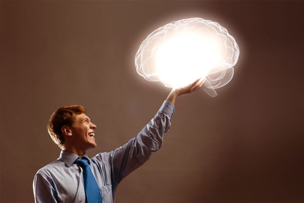 man holding image of human brain