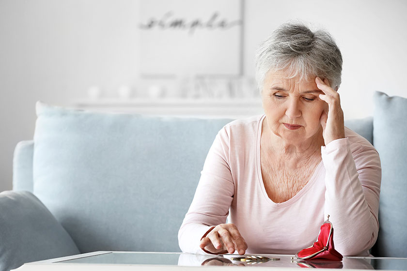 sad senior woman counting money
