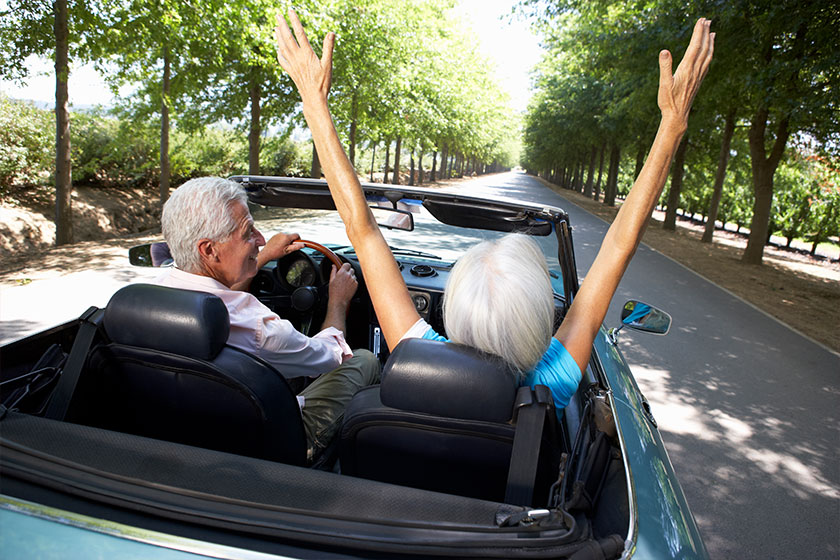 senior couple in sports car