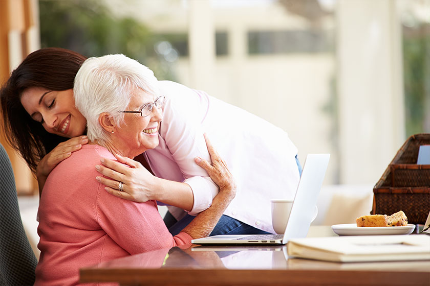 senior mother being comforted by daughter