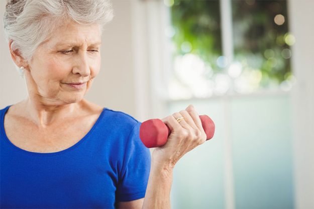 senior woman exercising with dumbbells senior woman exercising with dumbbells