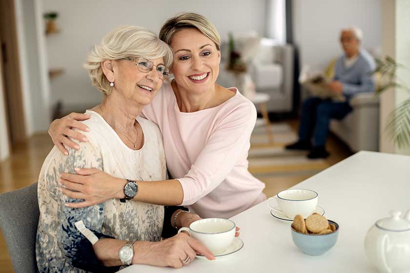 happy woman embracing her mature mother