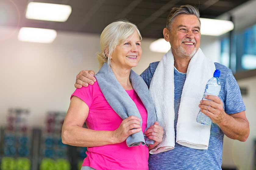 senior couple exercising in gym