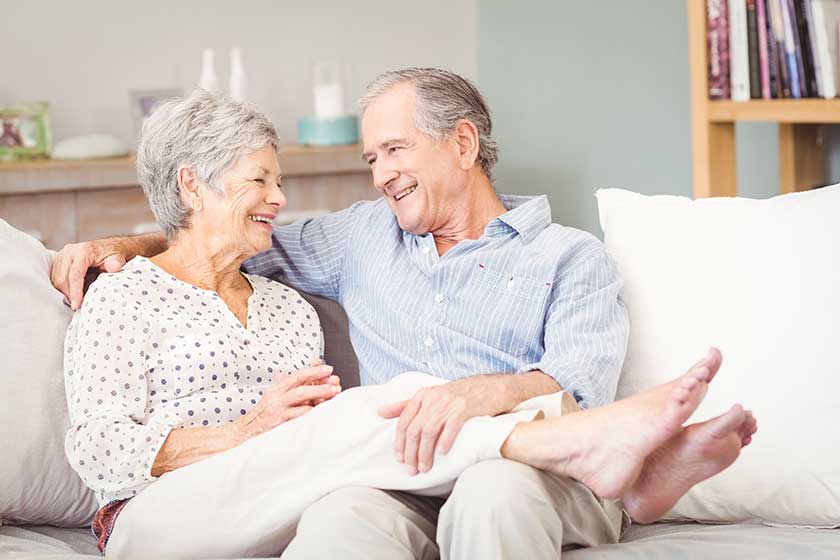 senior couple sitting on sofa
