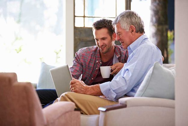 son helping senior father