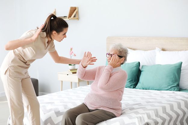 caregiver mistreating senior woman