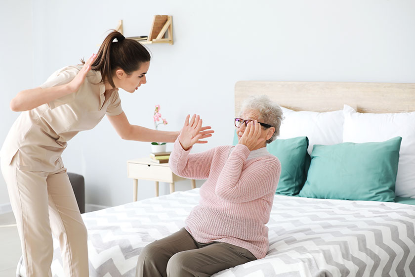 caregiver mistreating senior woman