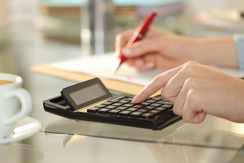 close woman hands using calculator