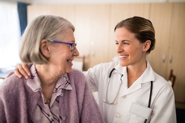 female doctor looking at senior woman