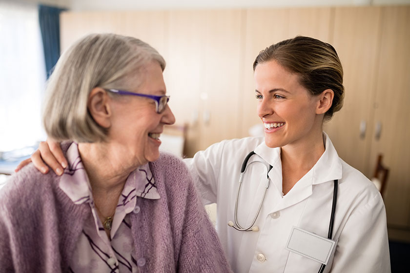 female doctor looking at senior woman