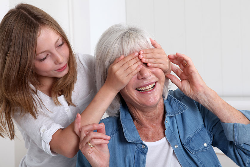 girl hiding her grandmother eyes