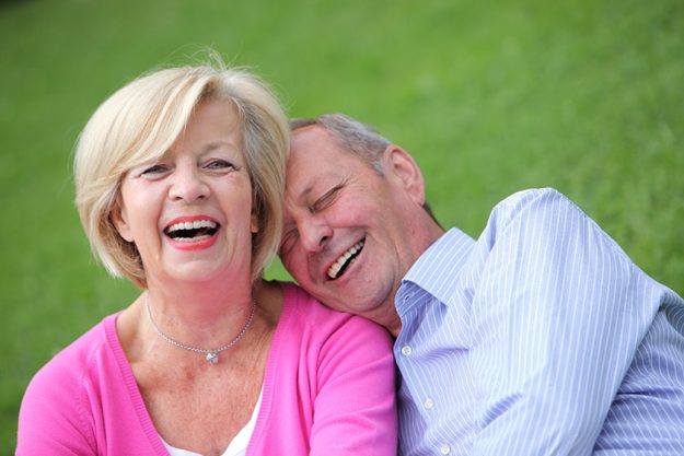 happy elderly couple laughing together happy elderly couple laughing together