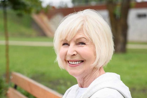 portrait cheerful senior woman sitting