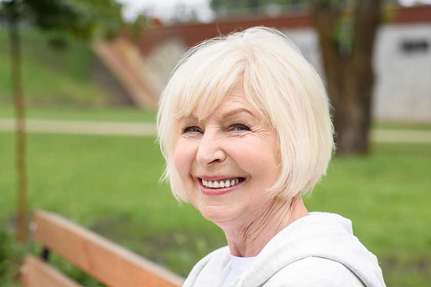 portrait cheerful senior woman sitting