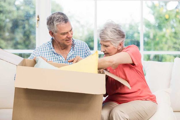 senior couple opening big box