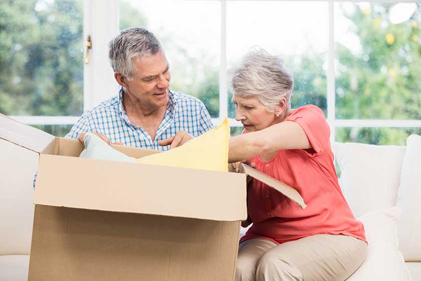 senior couple opening big box