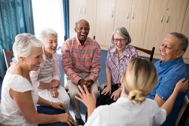 seniors sitting with female doctor on chairs