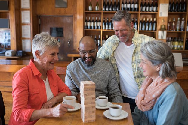 friends playing jenga game while