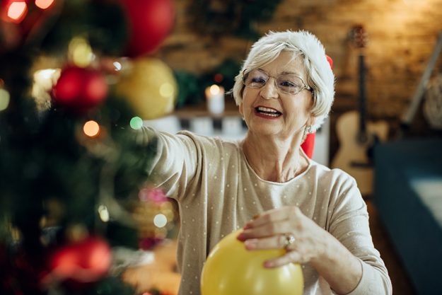 happy mature woman wearing santa
