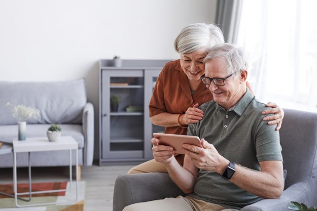 happy senior couple using tablet