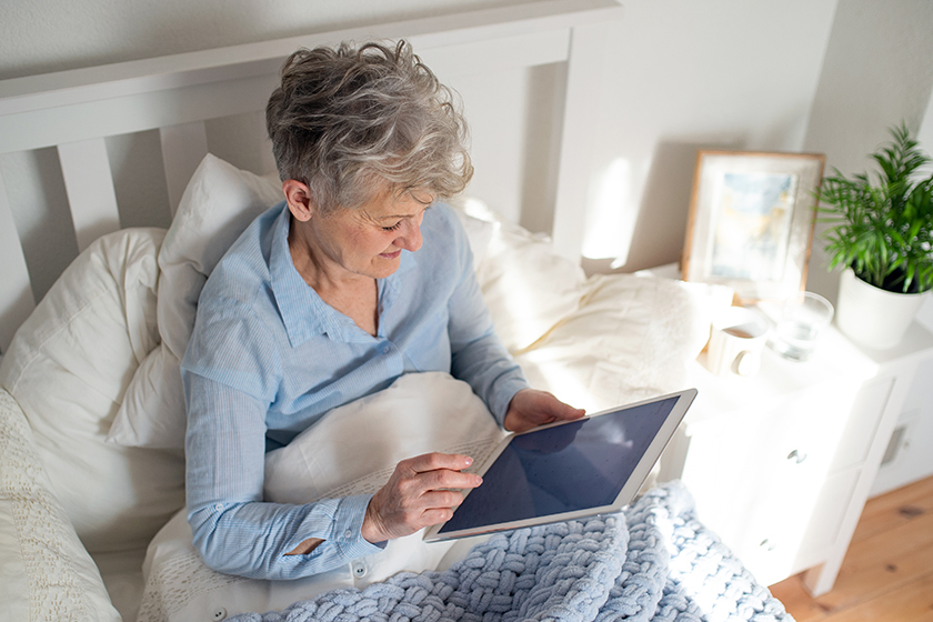 happy senior woman using tablet