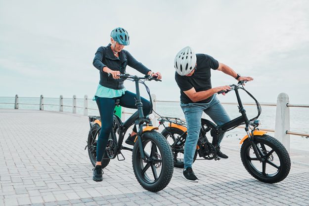 mature couple electrical checking bike