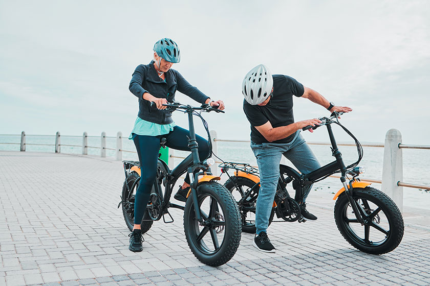 mature couple electrical checking bike