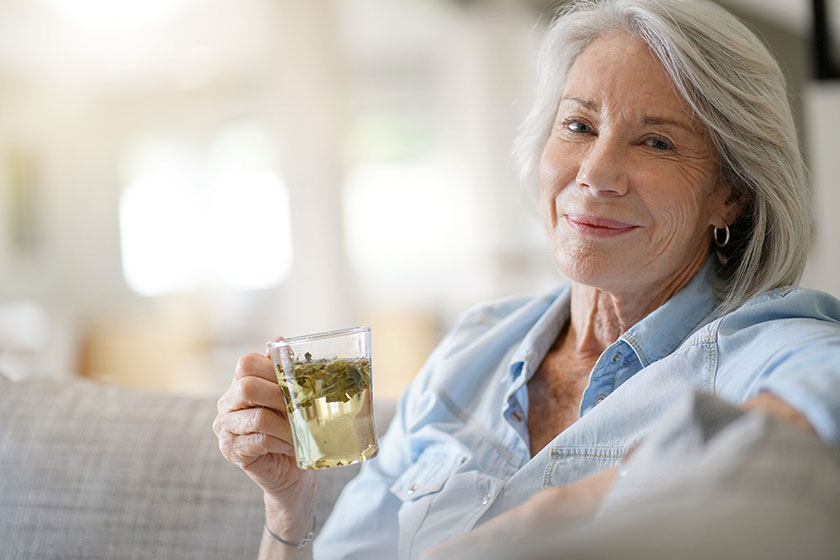 modern senior woman home tea