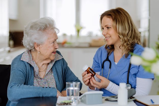 nurse giving pills senior woman 1 nurse giving pills senior woman 1