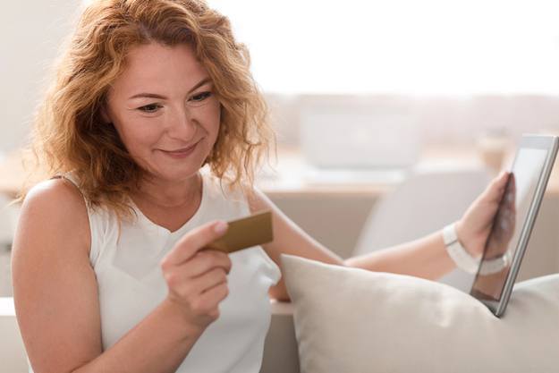 pleasant woman holding credit card