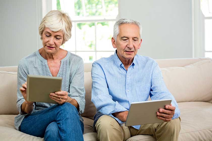 senior couple using tablet senior couple using tablet